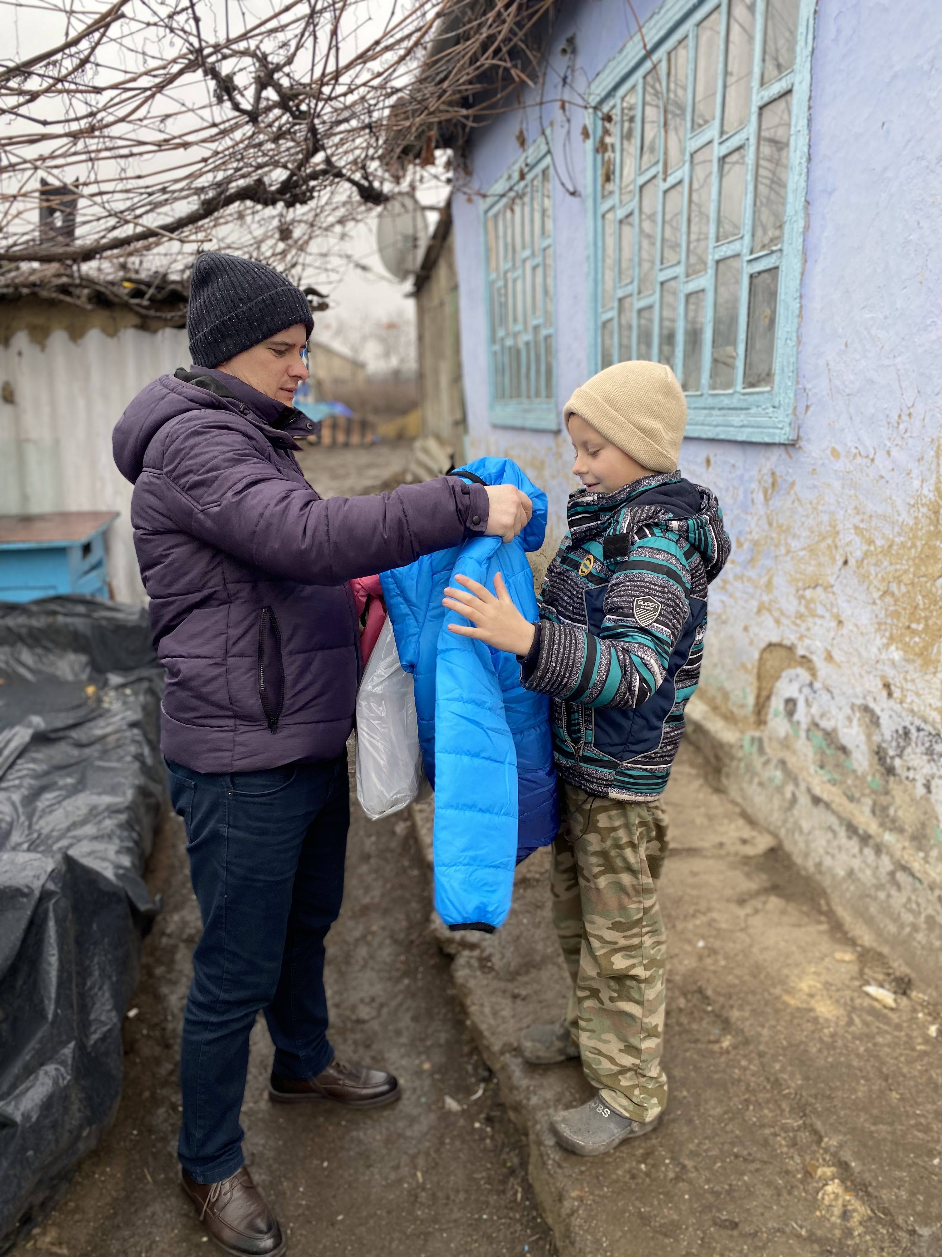 Pavel gives Sebastien a new donated winter coat.